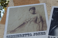  Sepia-toned historical photo of Sissieretta Jones in formal dress, displayed on the music mural.