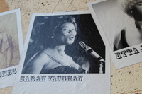Black-and-white photo of Sarah Vaughan singing at a microphone, displayed on the music mural.